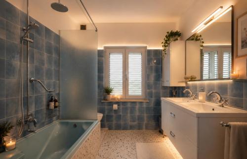 a bathroom with a tub and a sink at Villa Vale in Labin