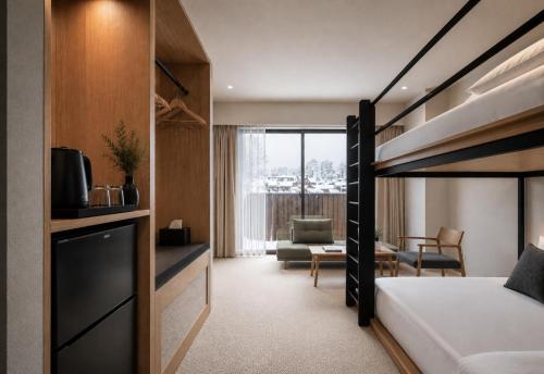 a bedroom with a bunk bed and a living room at Hotel Rima chocolat in Toyohira
