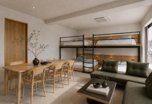 a living room with a dining table and bunk beds at Hotel Rima chocolat in Toyohira