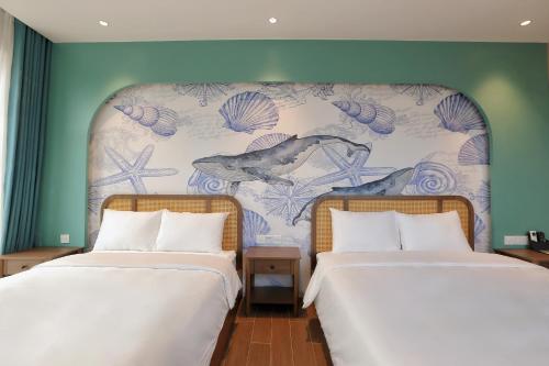 two beds sitting next to each other in a room at Sonasea Van Don Letavia Hotel in Thâm Câu