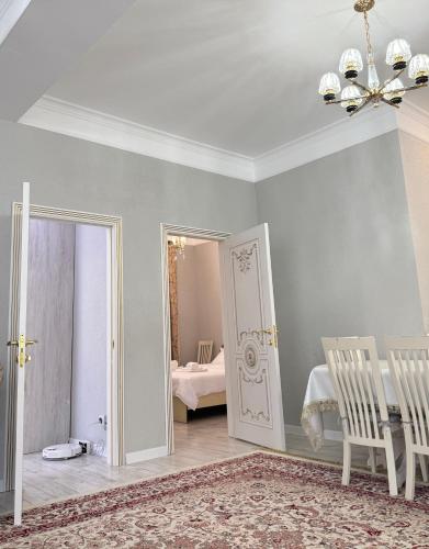 a room with a chandelier and a door with a bedroom at Cottage on Issyk-Kul, Royal Beach in Chok-Tal