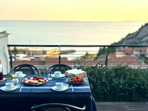 a table with plates of food on top of a balcony at Portopiccolo Apartments in Sistiana