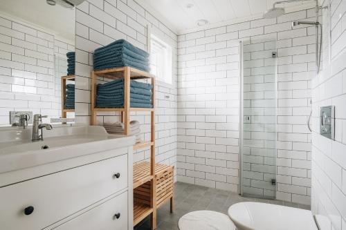 a white bathroom with a sink and a toilet at Batalden Ishus in Kinn