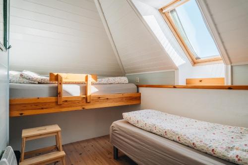 a bedroom with two bunk beds and a window at Batalden Ishus in Kinn