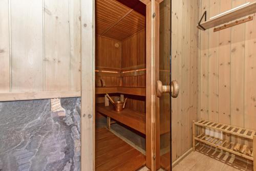 a wooden room with a small wooden shelf in a room at Aurora Resort in Stasiūnai