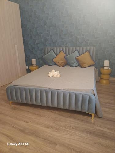 a bed in a room with a bedvisor with pillows at Domus San Francesco in Castelvetrano Selinunte