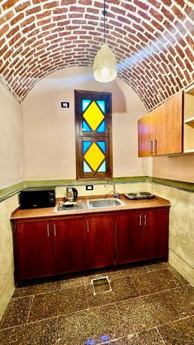 a kitchen with a sink and a window at El Juneina Villas - Luxury Boutique Villas Near Valley of the Kings in Luxor