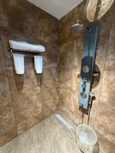 a bathroom with a shower with towels on the wall at Sri Vasavi Regency in Mahabalipuram