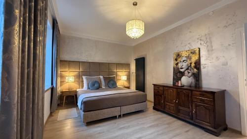 a bedroom with a bed and a dresser in it at "Na Prostej" Old Town Apartment in Olsztyn