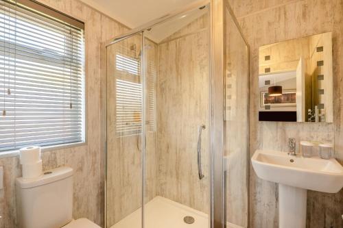 a bathroom with a shower and a toilet and a sink at 3 Bed in York oc-90401 in Riccall