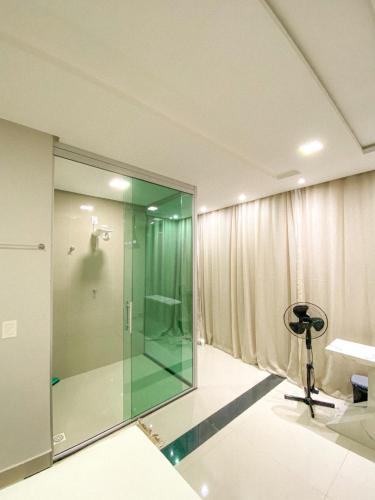 a bathroom with a glass shower in a room at Pousada Acessus Executivo - Cozinha e Lavanderia in Anápolis