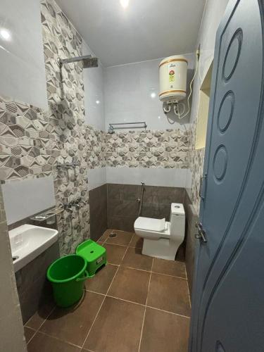 a small bathroom with a toilet and a sink at New Peak By The Lake in Chikmagalūr