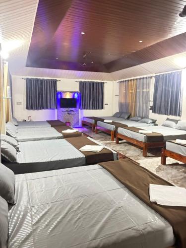 a room with a bunch of beds in it at New Peak By The Lake in Chikmagalūr