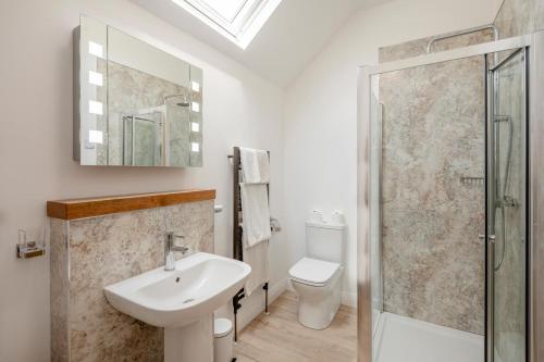 a bathroom with a sink and a toilet and a shower at 2 Bed in Driffield oc-79279 in Wold Newton