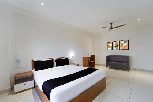 a bedroom with a large bed and a tv at Collection O Kottayam Railway Station in Kottayam