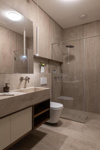 a bathroom with a sink and a toilet and a shower at Azamra in Uman