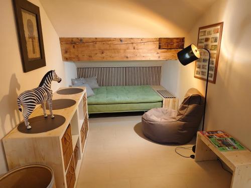 a room with a zebra on a counter and a bed at By Wallner's in Sankt Leonhard