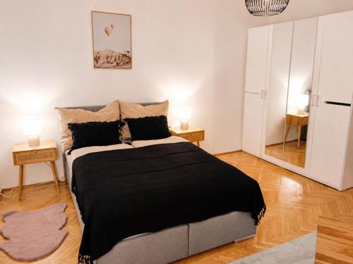 a bedroom with a large bed and two lamps at Faraway Homes Studio Enns #14 in Enns
