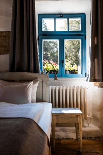 a bedroom with a bed and a window and a table at Podhlavický mlýn in Všelibice