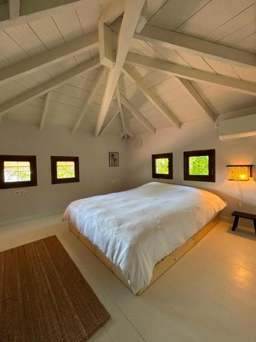 a bedroom with a large white bed in a room at The Hill House in Argalasti