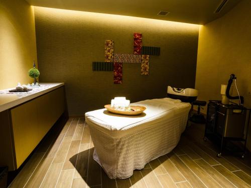 a room with a bed and a cross on the wall at Sheraton Okinawa Sunmarina Resort in Onna