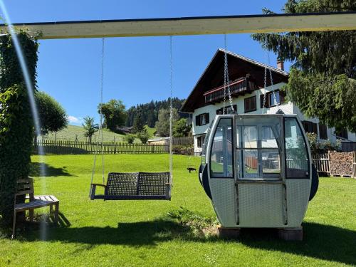 a swing in a yard with a house at Hus8 Krumbach in Krumbach