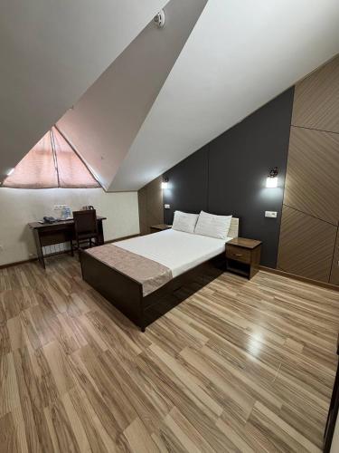 a bedroom with a large bed and a table at Tourist inn Tashkent in Toshkent-Passajir Bekati