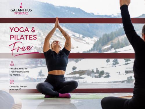 a woman doing yoga and pilates in front of a banner at Wuau! Hotel Galanthus & Spa in Soldeu