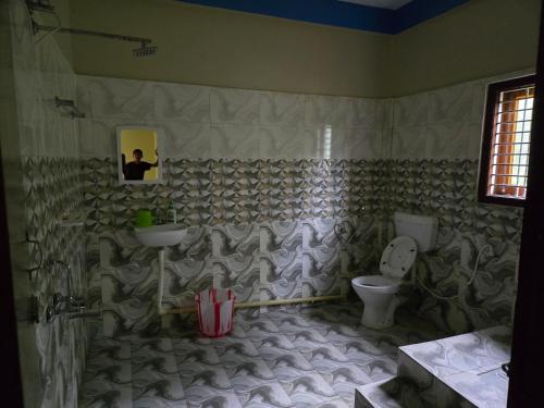 a bathroom with a sink and a toilet at Sharma Residency in Dithur