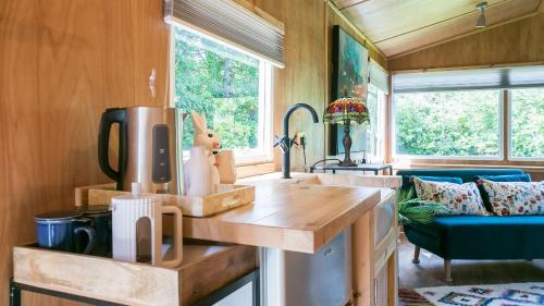 a kitchen in a tiny house with a counter top at Penrallt in Benllech