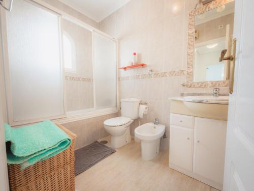 a white bathroom with a toilet and a sink at Luxury Private Pool Villa Campoverde in Pinar de Campoverde