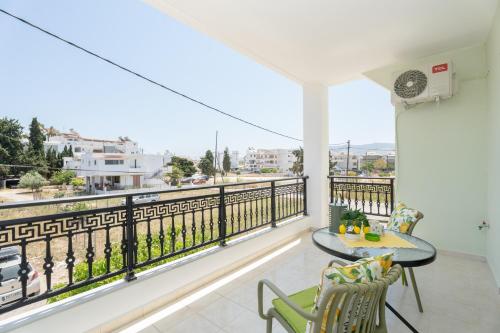 a balcony with a table and chairs and a view at Kos Happy living in Lampi