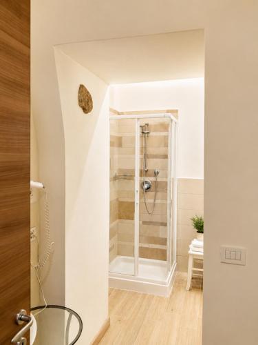 a bathroom with a shower and a glass table at Podere Meroli in Scorcetoli