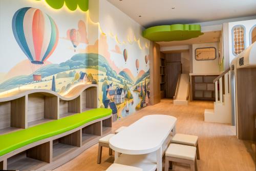 a childrens room with a mural of hot air balloons at Rich Palace Hotel in Surabaya