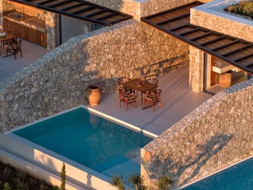 an external view of a house with a swimming pool at Doci Kelios - Serenity Suites with Private Heated Pools, by ZanteWize in Agios Nikolaos