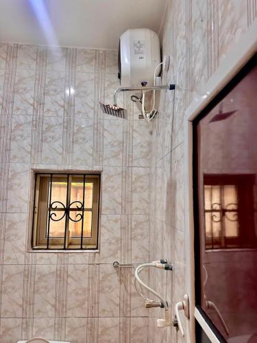 a bathroom with a shower and a window in it at Imtech Luxury Apartments in Uyo