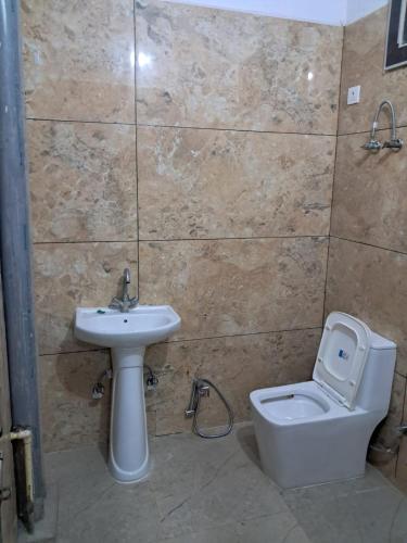 a bathroom with a sink and a toilet at PLAY HOTEL PREET RESIDENCY couple friendly in Greater Noida