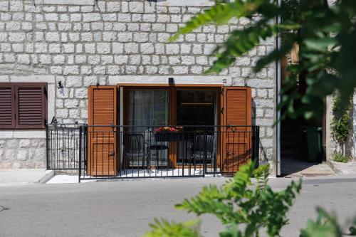 a building with an open gate with tables and chairs at Historic Waterfront Apartment in Muo