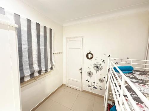 a white bedroom with a bed and a window at Rooms Granvia in Barcelona