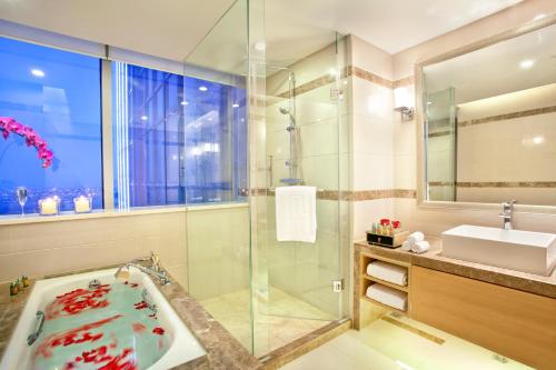 a bathroom with a tub and a sink at Regal Plaza Hotel & Residence in Shanghai