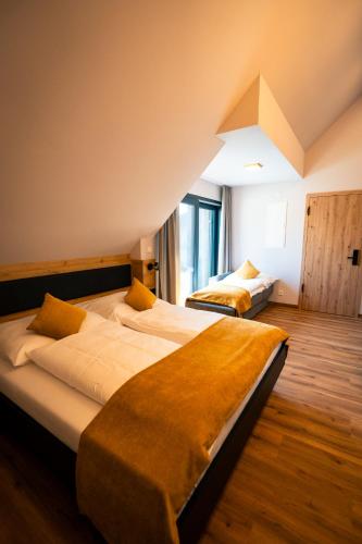 a bedroom with two beds in a room at Adler Apartments in Bach