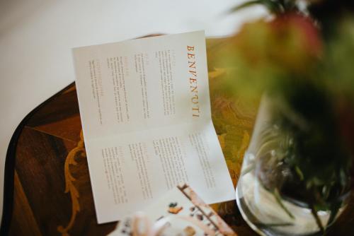 a menu sitting on top of a table with a vase at Casa Praie in Casasco