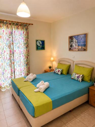a bedroom with a bed with towels on it at Studios Edem in Agios Ioannis Kaspaka