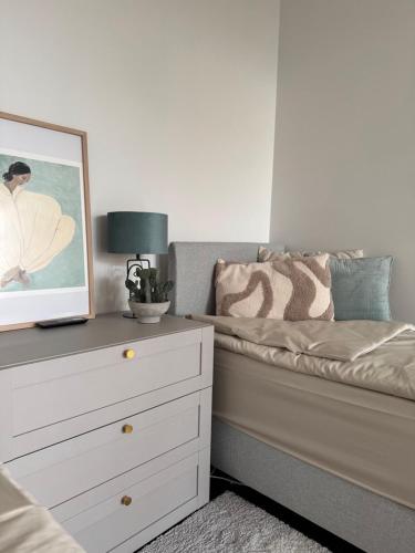 a bedroom with a bed and a dresser with a picture at Tamula Panorama in Võru