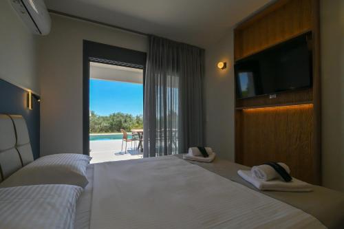 a hotel room with two beds and a view of a pool at Apex Premium Living in Leptokarya