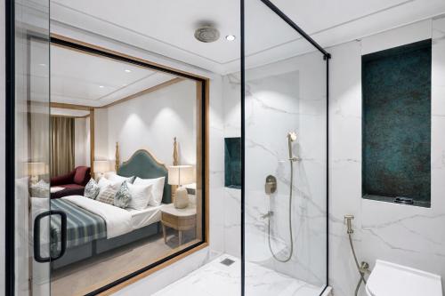 a bathroom with a shower and a bedroom with a bed at AB's Abode-A Boutique Hotel in Mussoorie