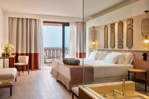 a hotel room with a bed and a tub at Barceló Tenerife Royal Level in San Miguel de Abona