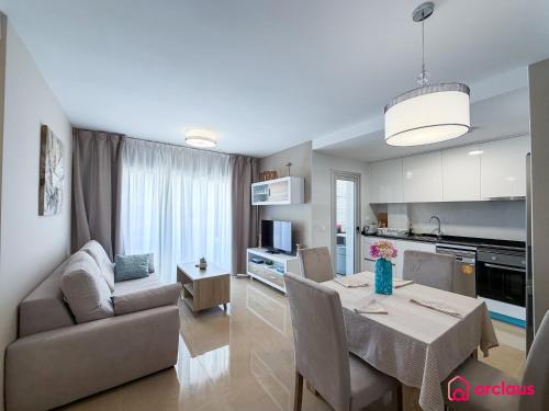 a kitchen and living room with a table and a couch at Sunwave in Cabanes