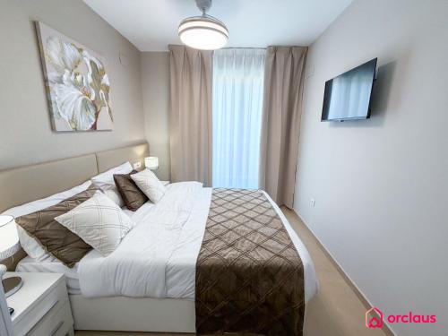 a bedroom with a bed and a television in it at Sunwave in Cabanes