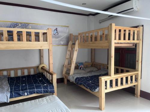 a room with two bunk beds and a bed at FUBON World Guesthouse in Ban Nongpapao